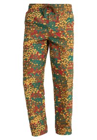 Flerfärgade byxor med splattermönster i grönt, gult, rött och brunt. Har en elastisk midja med dragsko och rak benpassform.