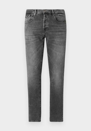 Jeans de mezclilla gris con corte ajustado, diseño de cinco bolsillos y costuras visibles. Presentan un cierre de botón y presillas para cinturón. Textura suave.