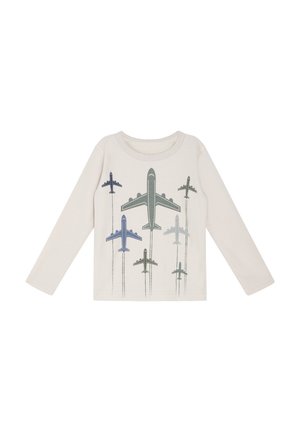 Langärmliges, hellbeige Hemd mit einem gedruckten Design verschiedener Flugzeuge in Blau- und Grüntönen, mit schwachen Zuglinien hinter jedem Flugzeug.