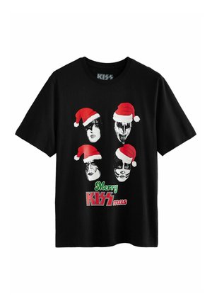 T-shirt en coton noir présentant quatre visages stylisés portant des bonnets de Père Noël rouges, avec "Joyeux KISSmas" en texte vert et rouge en dessous.