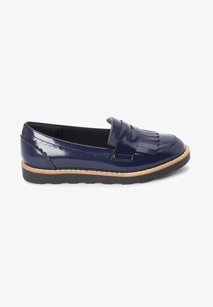 Navy patent leather loafer with a fringed accent, scalloped trim, and a contrasting tan sole. Features a low-profile design and smooth texture.