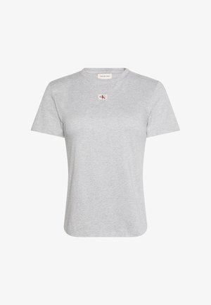 T-shirt court en coton gris clair avec un petit écusson logo Calvin Klein Jeans centré sous l'encolure ronde.