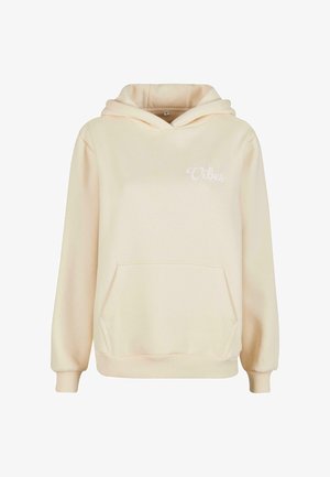 Krém színű kapucnis felső elülső zsebbel, húzózsinórral ellátott kapucnival, és a mellkason finoman hímzett "Csak jó vibrációk" felirattal.