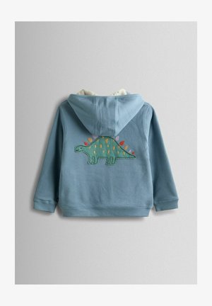 Sweat à capuche bleu en tissu texturé, avec un design de dinosaure cousu au dos, orné de pointes et accents colorés.