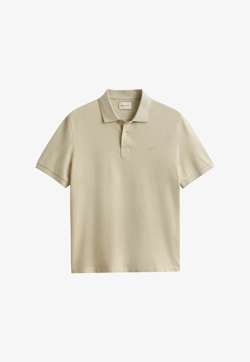 Polo beige de manga corta con cuello, tapeta de dos botones y un logo bordado sutil en el pecho izquierdo.