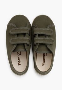 Green canvas slip-on shoes with two Velcro straps, white rubber soles, and subtle stitching details. Interior features a brand logo.