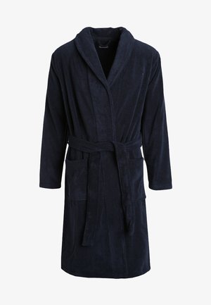 Tamsiai mėlynas vonios chalatas, pagamintas iš minkštos, sugeriančios medžiagos. Su šalikine apykakle, dirželiu juosmens srityje ir dviem priekinėmis kišenėmis.