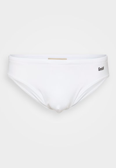 Bas de maillot de bain blanc en tissu lisse, à taille basse et au design minimaliste, avec un logo discret sur le côté.