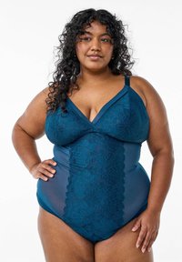 Costume intero teal con dettagli in pizzo, scollatura a V, spalline regolabili e pannelli solidi. Tessuto liscio con motivi floreali.