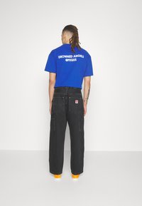 Carhartt WIP NASH PANT SMITH - Relaxed fit jeans - black stone washed