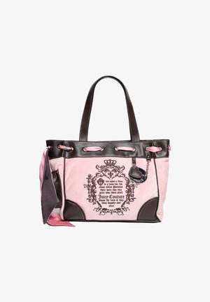 Pink suede tote bag with dark brown leather accents, dual handles, decorative text, and a charm. Features a soft texture and contrasting colors.