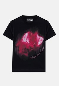 Black cotton t-shirt featuring a front graphic of pink flowers and "Versace Jeans Couture" in a cursive font, with a soft texture.