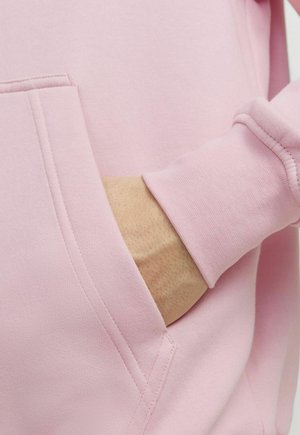 Light pink hoodie with a front pocket, featuring a smooth texture and ribbed cuffs. Simple design with clean stitching details.