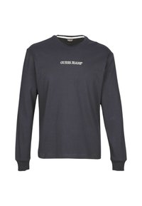T-shirt a maniche lunghe di color navy realizzato in cotone, con scollo a girocollo e logo "GUESS JEANS" bianco sul petto. Tessuto liscio e vestibilità regolare.