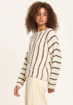 Knitted sweater featuring ivory base with brown fuzzy vertical stripes, round neckline, and long sleeves. Soft, textured fabric.