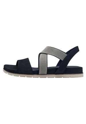 Sandalo blu in suede con due bande elastiche incrociate, punta aperta e suola leggera beige. Presenta una cinghia testurizzata per dettagli aggiuntivi.