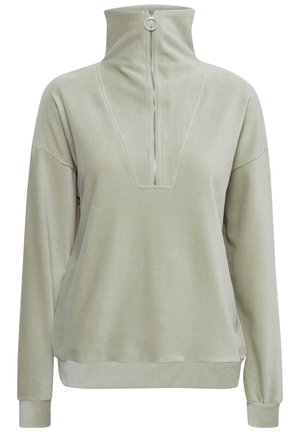 Ljusgrön fleece-tröja med hög krage, en fjärdedels dragkedja fram och ribbade ärmslut; har en V-formad sömdetalj på bröstet.