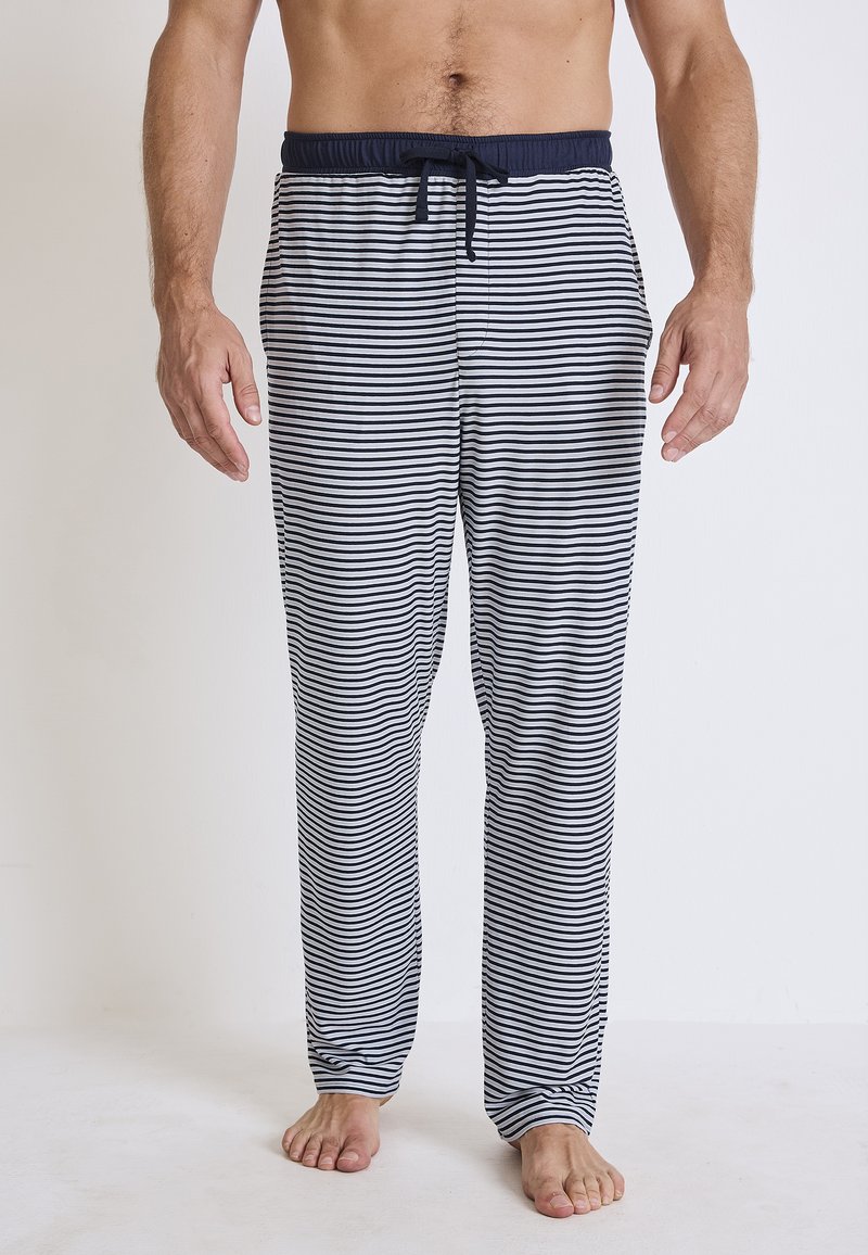 Streepjesslaapbroek in marineblauw en wit, met een elastische tailleband met een trekkoord en een losse pasvorm voor comfort.