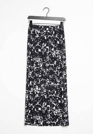 Schwarz-weiß geblümter Maxirock mit elastischem Bund, der an einem schwarzen Kunststoffkleiderbügel vor weißem Hintergrund hängt.