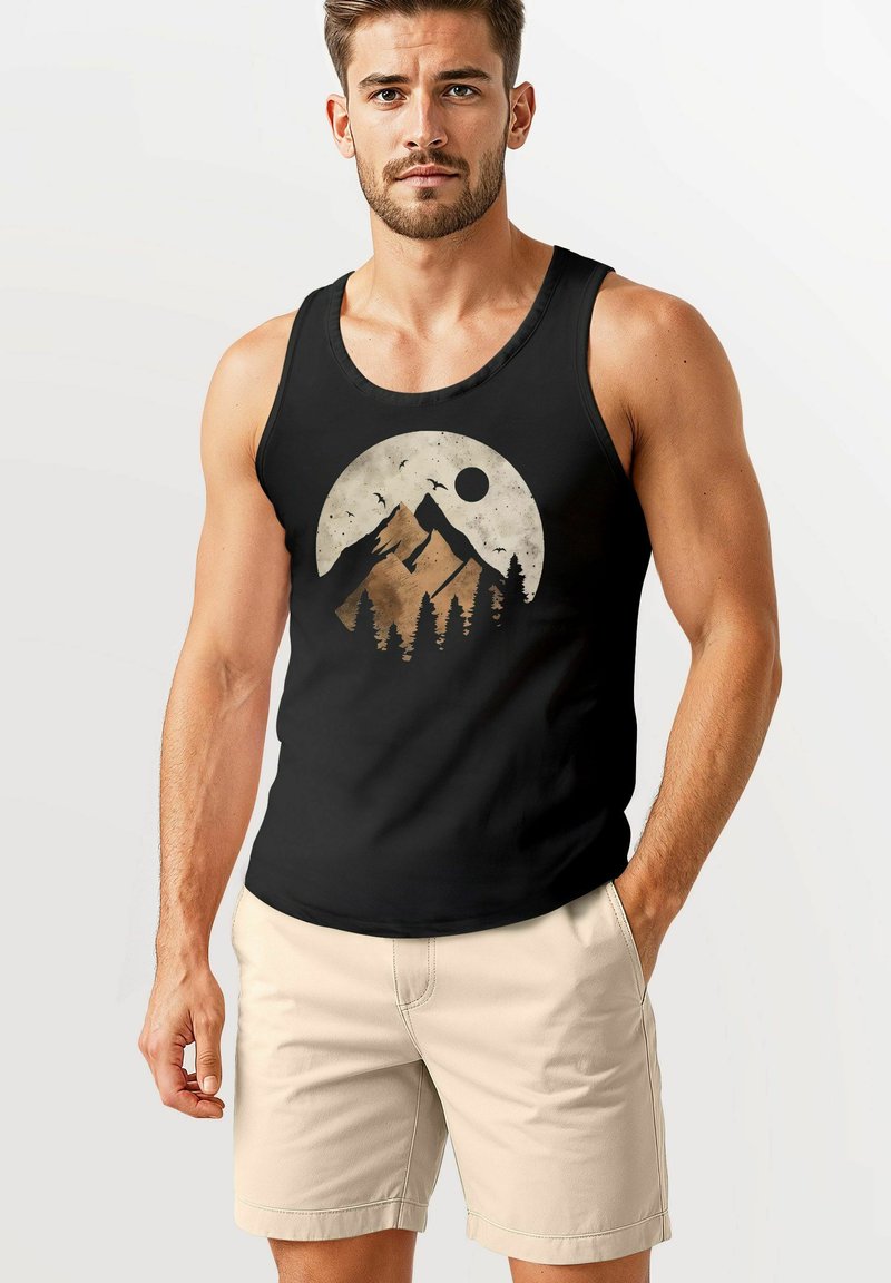 Black tank top featuring a circular mountain and sun graphic in earthy tones, worn with light beige shorts, made from cotton blend fabric.