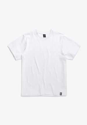 T-shirt bianco in cotone con maniche corte, scollatura rotonda, texture liscia e un piccolo etichetta nera del brand sul lato sinistro in basso.