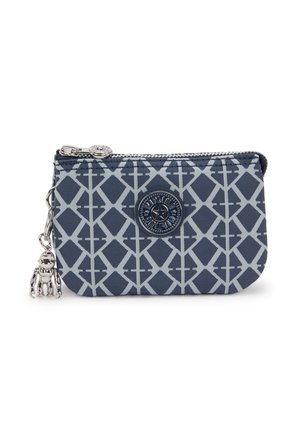 Navy blue fabric pouch with light gray geometric pattern, zipper closure, circular logo patch, and a silver charm accent.