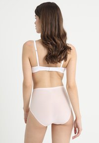 White bralette with adjustable straps and high-waisted sheer pink panties. Soft, smooth fabric with a simple, minimalist design.