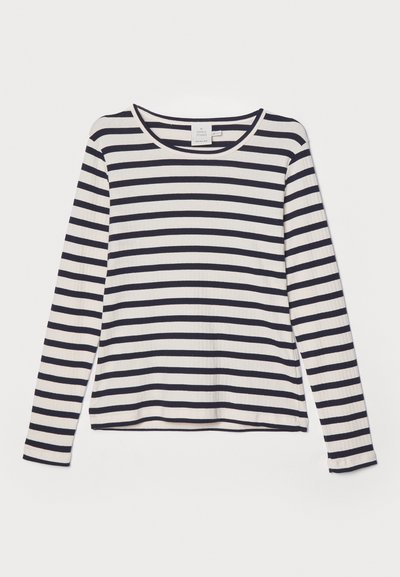Long-sleeve shirt in cream with navy horizontal stripes, featuring a round neckline, ribbed texture, and relaxed fit.