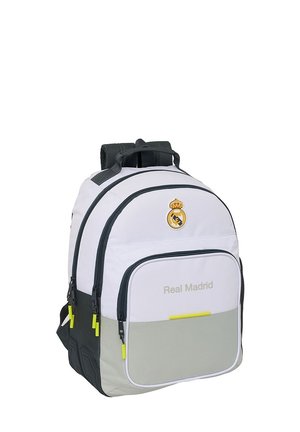 Zaino bianco e grigio con numerosi scomparti con zip, logo del Real Madrid sulla parte superiore e testo "Real Madrid" sulla tasca anteriore.