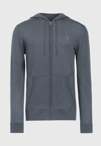 Haut à capuche zippé gris en tissu doux, avec une poche kangourou, des poignets côtelés et une capuche avec des cordons de serrage. Petit logo sur la poitrine.