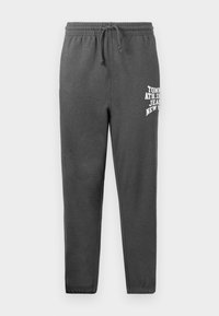 Grijze sweatpants van zachte stof, met een elastische tailleband met trekkoord, en een witte logo-print op het linkerbeen.