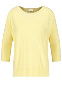 Ljusgul långärmad topp med vid halsringning, ribbat mönster vid ärmar och nederkant, samt en avslappnad passform. Slät tyg, minimalistisk design.