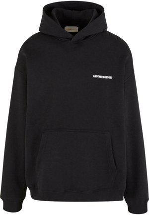 Hoodie noir en mélange de coton, avec une poche avant et le texte "ANOTHER COTTON" en blanc. Coupe décontractée avec un capuche à cordon de serrage et des poignets côtelés.