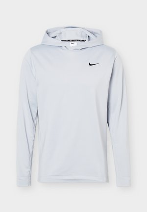 Sweat à capuche manches longues Nike gris clair avec petit logo swoosh noir sur la poitrine, présenté sur un fond uni.