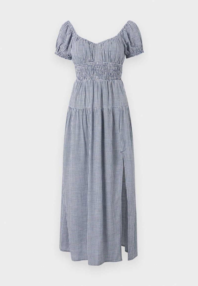 Checkered blue and white dress with short puff sleeves, smocked bodice, and a flowing skirt featuring a side slit.