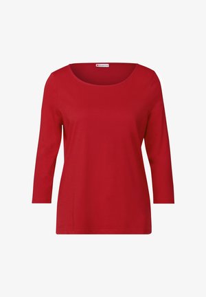 Czerwona bawełniana bluzka z długim rękawem, okrągłym dekoltem i luźnym krojem. Gładka tekstura bez widocznych wzorów czy elementów metalowych.