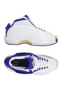 Scarpe sportive bianche con dettagli blu e gialli; parte superiore in sintetico liscio, colletto imbottito e suola in gomma testurizzata.