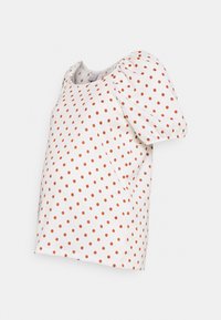 Blusa branca com mangas bufantes, apresentando um padrão de bolinhas laranjas. O tecido parece leve e com uma textura suave.