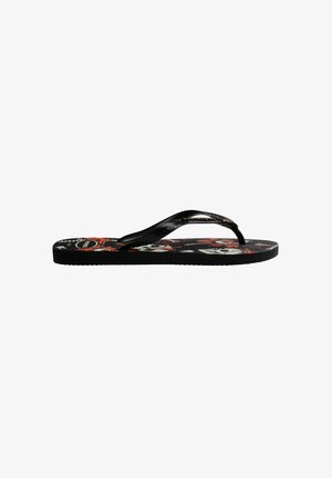 Chanclas negras con tiras texturizadas y un patrón floral en la planta en rojo, blanco y negro. Suela plana con un acabado suave.