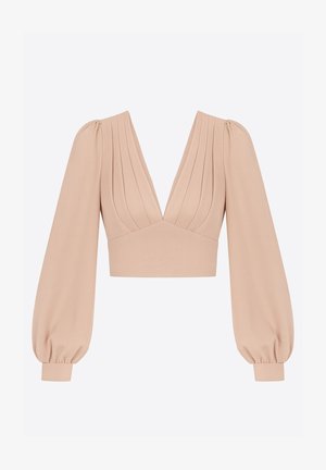 Haut court à manches bouffantes en beige clair, avec un décolleté en V profond, un corsage plissé et des poignets élastiques pour une coupe structurée. Texture de tissu lisse.