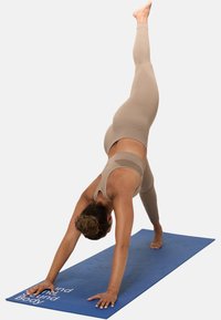 Yoga mat in blue with textured surface; person in beige activewear performing a downward dog pose, with one foot elevated.