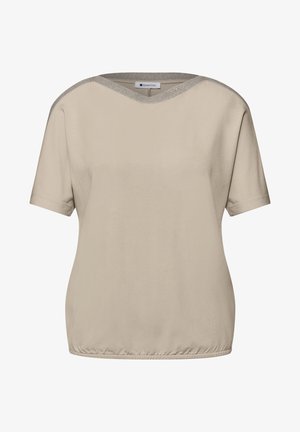 Blouse beige à manches courtes avec finition scintillante subtile sur l'encolure ronde et ourlet élastiqué, vue de face.