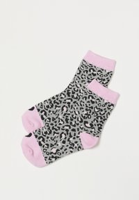 Un par de calcetines hasta el tobillo con un estampado de leopardo gris y puños de un rosa claro. Están hechos de una tela suave y presentan una combinación de patrones en negro y rosa.