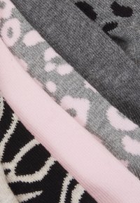 Set of five fabric swatches featuring grey, pink, and black colors with various patterns, including spots and stripes, displayed in a stacked arrangement.