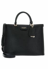 Borsa nera texturizzata con manici doppi, tracolla rimovibile, dettagli in oro e un piccolo charm attaccato. Logo del brand visibile sul fronte.