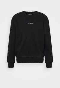Svart långärmad crewneck sweatshirt med råa kanter och liten vit text "HAN KJØBENHAVN" centrerad på bröstet.