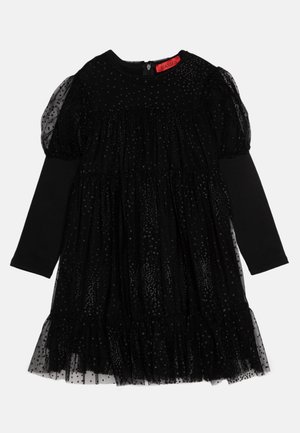 Black dress featuring a tulle overlay with dotted patterns, long sleeves, and a gathered waist. Back zip closure and soft lining.