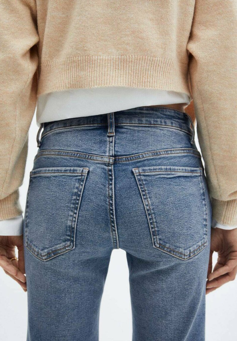 Blauwe denim jeans met een hoge taille, vijf zakken en een slanke pasvorm. De stof heeft een lichte textuur, met contrasterende stikdetails.