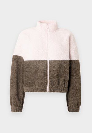 Ζακέτα από φλις με κοντό σχέδιο, με το επάνω μισό σε ανοιχτό ρόζ και το κάτω μισό σε σκούρο καφέ. Διαθέτει ψηλό γιακά και κλείσιμο με φερμουάρ.