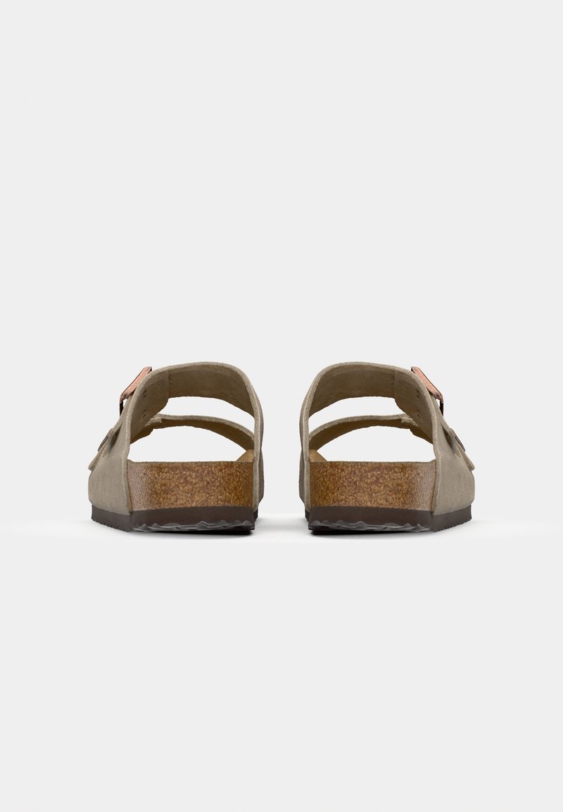 Brown suede sandals with a cork footbed, open back, dual straps, and a small adjustable buckle, featuring a textured rubber outsole.